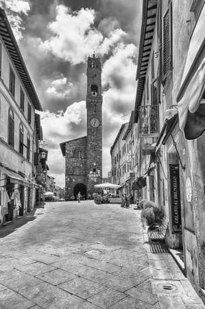 MONTALCINO, ITALY - JUNE 23: The medieval Palazzo dei Priori and the iconic clocktower, one of the main landmarks in Montalcino, province of Siena, Tuscany, Italy, as seen on June 23, 2019のeditorial素材