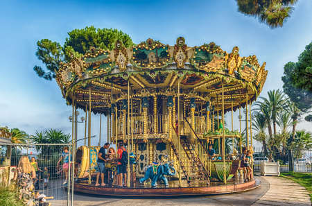 NICE, FRANCE - AUGUST 11: The scenic vintage Carrousel de la Coulee Verte inside a beutiful green park on the Promenade des Anglais, Nice, Cote d'Azur, France, as seen on August 11, 2019のeditorial素材