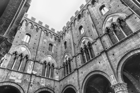 Scenic view from the bottom at the patio of Palazzo Pubblico, major landmark in Siena, Italyのeditorial素材
