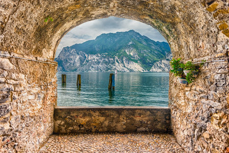 Scenic rock arch balcony overlooking Lake Garda from the town of Torbole, Italyの写真素材