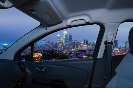 Looking through a car window with view of Philadelphia skyline at night as seen from the Stadium District, USAの写真素材