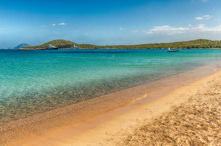 Luxury yachts standing in front of Liscia Ruja, one of the most beautiful beaches in Sardinia, Italyの写真素材