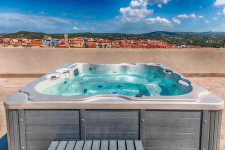Modern luxurious pool with hydromassage overlooking the town of Santa Teresa Gallura, located on the northern tip of Sardinia in the province of Sassari, Italyの写真素材