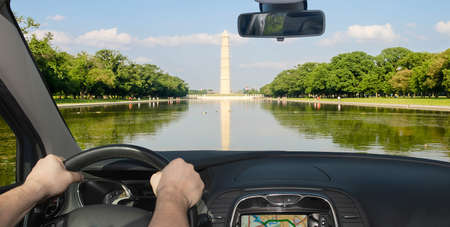 Driving a car towards the Washington Monument and Reflecting Pool, Washington DC, USAの写真素材