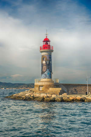 SAINT-TROPEZ, FRANCE - AUGUST 16: The iconic lighthouse in the harbor of Saint-Tropez, Cote d'Azur, France, August 16, 2019. The town is a worldwide famous resort for the European and American jet set and touristsのeditorial素材