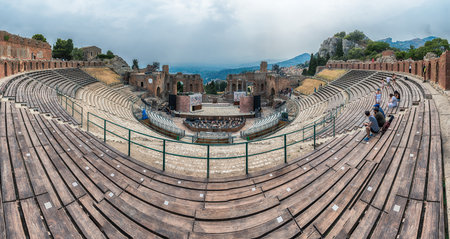 TAORMINA, ITALY - AUGUST 11, 2021: Scenic view inside the Ancient theatre of Taormina, Sicily, Italy. It was built in the third century BC and it's stiil used today as a venue for the annual arts festivalのeditorial素材