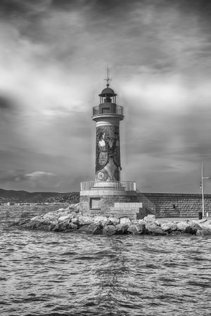SAINT-TROPEZ, FRANCE - AUGUST 16: The iconic lighthouse in the harbor of Saint-Tropez, Cote d'Azur, France, August 16, 2019. The town is a worldwide famous resort for the European and American jet set and touristsの写真素材