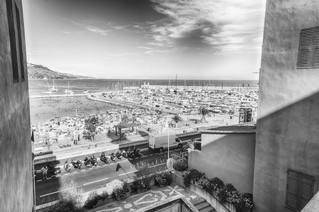 Scenic view over the beach in the city centre of Menton, Cote d'Azur, France, with the Italian coastline in the backgroundの写真素材