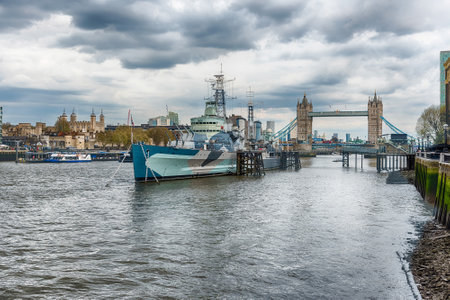 LONDON - APRIL 14, 2022: View over HMS Belfast, historical cruiser built for the Royal Navy, now permanently moored as a museum ship on the River Thames in London, England, UKのeditorial素材