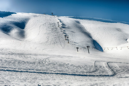 Scenic winter landscape with snow covered mountains, located in Campocatino, touristic ski town in the Central Apennines, Italyの写真素材
