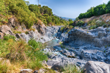 The impressive natural system of gorges and ravines eroded over the last millennia by the river Alcantara through the crystallized lava flown from Mount Etna. Located near Taormina, Sicily, Italyの写真素材