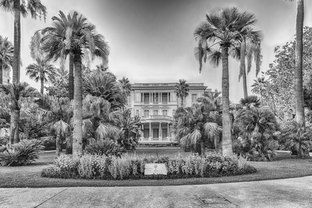 NICE, FRANCE - AUGUST 11: Facade of Musee Massena inside a beautiful garden with palms located on the Promenade des Anglais in Nice, Cote d'Azur, France, as seen on August 11, 2019のeditorial素材