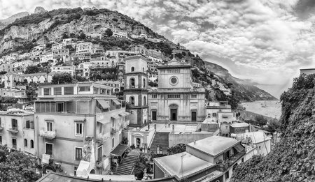 Panoramic view with the facade of the Church of Santa Maria Assunta, iconic landmark in Positano, on the Amalfi Coast of southern Italyの写真素材