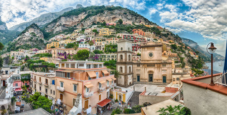 Panoramic view with the facade of the Church of Santa Maria Assunta, iconic landmark in Positano, on the Amalfi Coast of southern Italyの写真素材