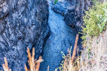 The impressive natural system of gorges and ravines eroded over the last millennia by the river Alcantara through the crystallized lava flown from Mount Etna. Located near Taormina, Sicily, Italyの写真素材