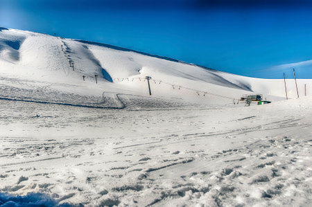 Scenic winter landscape with snow covered mountains, located in Campocatino, touristic ski town in the Central Apennines, Italyの写真素材