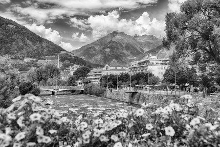 The Passirio River is flowing through the city center of Merano, a famous spa town in South Tyrol, Italy, surrounded by mountainsの写真素材