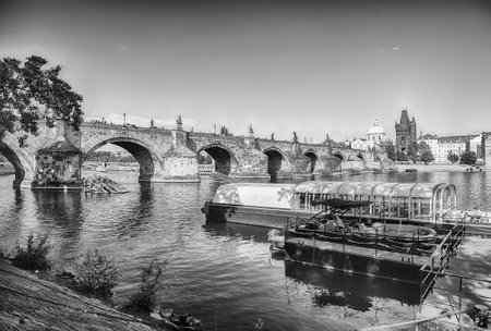 Charles Bridge crossing the Vltava River on a sunny day with the buildings of old town in the background in Prague, Czech Republicの写真素材