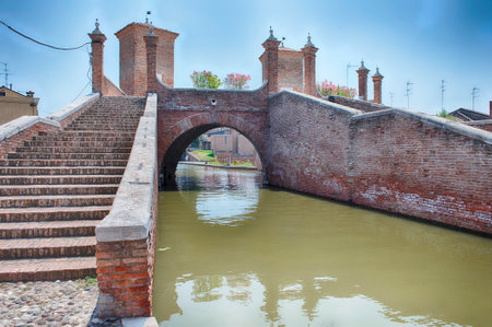 View over the Trepponti Bridge, a masonry arch bridge and iconic landmark in Comacchio, Italyの写真素材