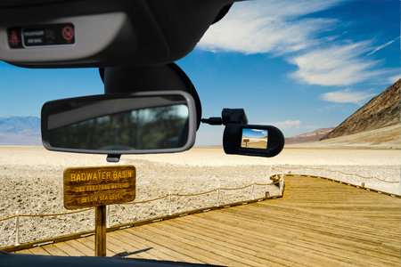 Looking through a dashcam car camera installed on a windshield with view of Badwater Basin, the lowest elevation point in USA, Death Valley National park in Californiaの写真素材