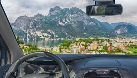 Looking through a car windshield with view of Riva del Garda, Lake Garda, Italyの写真素材