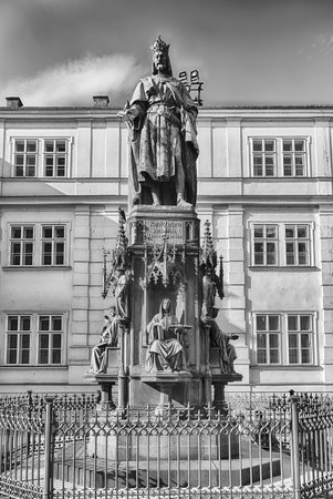 Bronze statue of Charles IV, holy Roman emperor, standing tall in Prague, Czech Republic with a bright blue skyの写真素材