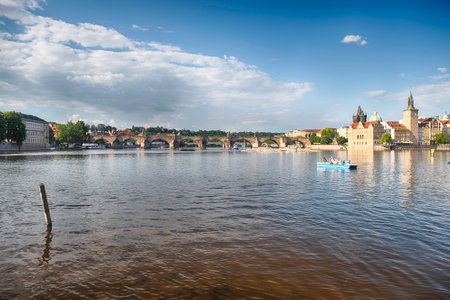 Charles Bridge crossing the Vltava River on a sunny day with the buildings of old town in the background in Prague, Czech Republicの写真素材