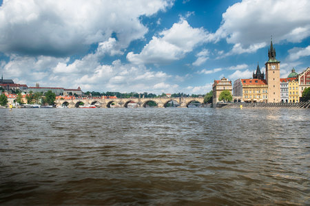 Charles Bridge crossing the Vltava River on a sunny day with the buildings of old town in the background in Prague, Czech Republicの写真素材