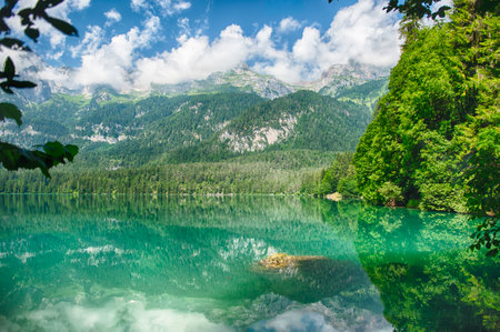 Panoramic view of the beautiful Lake Tovel with the Brenta Dolomites in the background on a sunny summer day, Trentino Alto Adige, Italyの写真素材