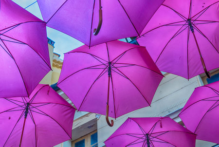 Iconic pink umbrellas decorating the city streets in the historic center of Grasse, Cote d'Azur, Franceの写真素材