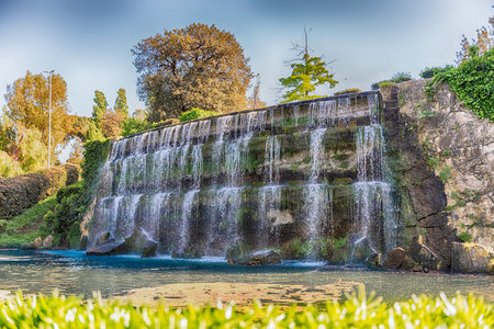 Scenic waterfall in the big fountain of EUR artificial lake, modern district in the south of Rome, Italyの写真素材