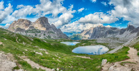 Scenic view of alpine Piani Lakes reflecting peaks of the Sexten Dolomites, South Tyrol, Italyの写真素材