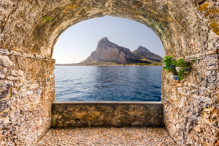 Scenic rock arch balcony overlooking the beautiful nature and seascape in San Vito Lo Capo, Trapani, Italyの写真素材