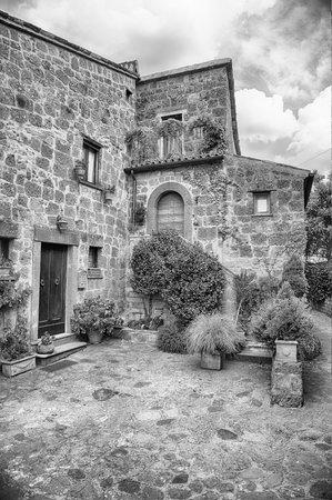 This black and white image showcases historic stone buildings with intricate details and abundant...