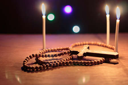 crucifix with rosary on wooden floorの写真素材
