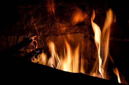 Closeup photo of blazing and warming fireplace in the cold evening.の写真素材
