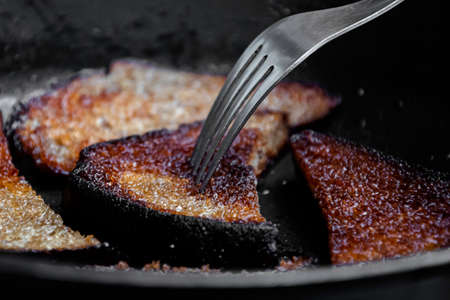 Fried in oil crunchy bread pieces. Cooking process.