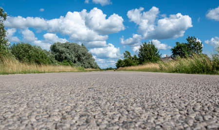 Rural landscape. Leading forward country road in summer.の写真素材