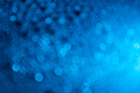 Abstract bokeh effect background of transparent water drops with blue coloured LED light.の写真素材