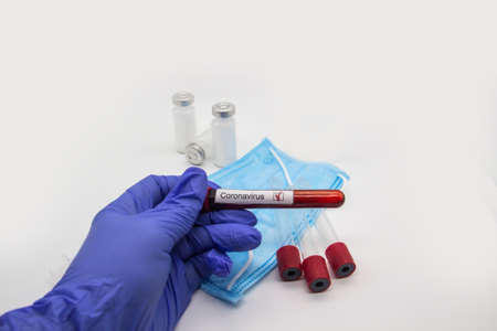 Coronavirus blood test 2019. Doctor hand in medical glove holding test tube with Coronavirus...
