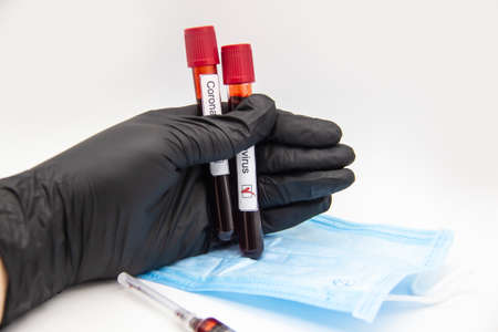 Coronavirus blood test 2019.Coronavirus came Doctor hand in medical glove holding test tubes with...