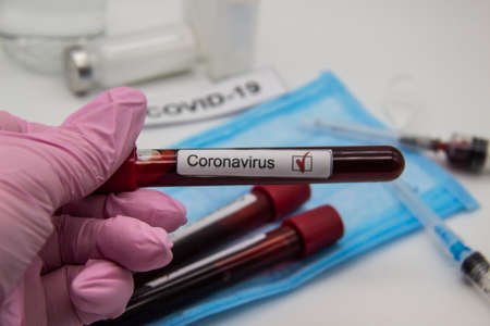 Coronavirus blood test 2019.. Doctor hand in medical glove holding test tube with Coronavirus...