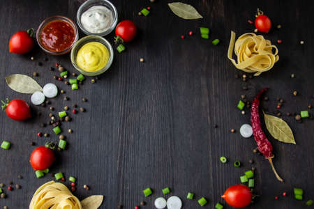Cooking food background with free space for text. Composition with ingredients over the wood background. Ingredients for cooking with copy space. Top view with copy spaceの写真素材
