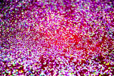 the abstract background with sparkles and glitters. A glitter in the red liquid. Colorful glitter on the background.の写真素材