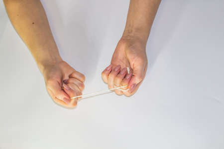 Women's hands hold the rope in the light background. Female hands pull the rope between each other....