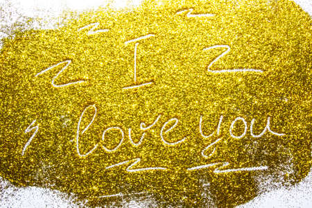 a composition with written a words i love you on beautiful gold glitter. Background and texture of gold glitter. Luxury gold glitter sparkle shining texture backgroundの写真素材