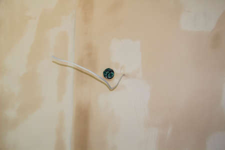 Repair work in the apartment with wire of electricity Concept of home improvement or renovate.