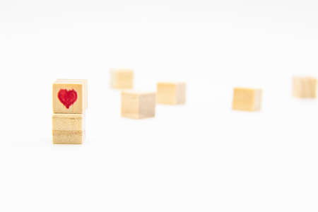 A heart drawn on the wood cubes. A Heart on the wooden cubes isolated on whiteの写真素材