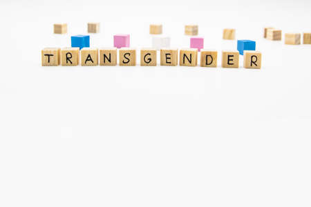 A word transgender lettering made of wooden cubes and  flag on white background.の写真素材