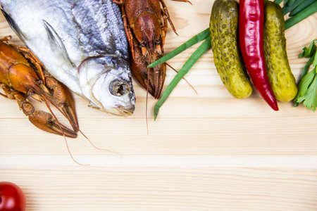 Composition with crayfish, dry fishes, pepper, tomatoes, parsley, pickled cucumbers. Cooking food...